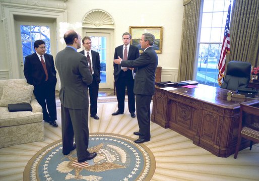 Shortly before delivering his remarks to the media, President George W. Bush discusses his decision regarding the University of Michigan Admission policies with, from left to right, Counsel Alberto Gonzales, Press Secretary Ari Fleischer, Assistant Jay Lefkowitz and Communications Director Dan Bartlett in the Oval Office Wednesday, Jan. 15, 2003. White House photo by Paul Morse