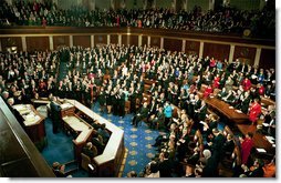 Congress applauds President Bush during his State of the Union Address at the U.S. Capitol Tuesday Jan. 28, 2003. Discussing the spread of the AIDS virus, President Bush asked Congress to commit $15 billion in aid for African nations and the Caribbean tormented by the disease. “The qualities of courage and compassion that we strive for in America also determine our conduct abroad,” said the President. “This conviction leads us into the world to help the afflicted, and defend the peace, and confound the designs of evil men.”   White House photo by Paul Morse