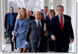 President George W. Bush and Italian Prime Minister Silvio Berlusconi walk along the colonnade after holding a joint press conference in the Oval Office Thursday, Jan. 30, 2003.  White House photo by Tina Hager