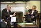 Reviewing a report about the Space Shuttle Columbia tragedy, President George W. Bush meets with NASA Administrator Sean O'Keefe in the Oval Office Monday, Feb. 3, 2003. White House photo by Eric Draper