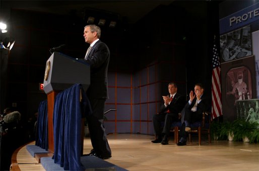 As Secretary of Homeland Security Tom Ridge, left, and Secretary of Health and Human Services Tommy Thompson listen, President George W. Bush discusses plans to protect America against biological attack at the Vaccine Research Center of the National Institute of Health in Bethesda Md., Monday, Feb. 3, 2003. "Project BioShield will give our scientific leaders greater authority and flexibility in decisions that may affect our security," explained the President. "Our labs will be able to hire the experts, get more funding quickly, and build the best facilities to accelerate urgently needed discoveries." White House photo by Paul Morse