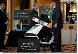 President George W. Bush looks over a scooter powered by solid hydrogen fuel during a demonstration of energy technologies at The National Building Museum in Washington, D.C., Thursday, Feb. 6, 2003. "Cars that will run on hydrogen fuel produce only water, not exhaust fumes," said the President in his remarks. "If we develop hydrogen power to its full potential, we can reduce our demand for oil by over 11 million barrels per day by the year 2040."  White House photo by Paul Morse