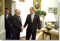 President George W. Bush welcomes Australian Prime Minister John Howard to the Oval Office Monday, Feb. 10, 2003. After meeting privately, the two leaders held a joint press conference in which they discussed disarmament in Iraq.   White House photo by Paul Morse