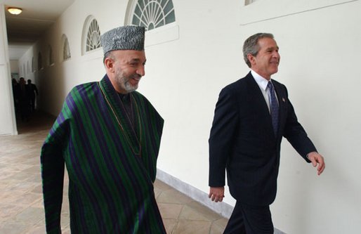 President George W. Bush and President Hamid Karzai of Afghanistan walk through the colonnade after meeting in the Oval Office Thursday, Feb. 27, 2003. White House photo by Tina Hager.