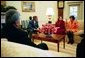 President George W. Bush listens to Dr. Katrin Michael, at right, Della Jaff and Idres Hawarry, foreground, in the Oval Office Friday, March 14, 2003. The three are from the Kurdish area of Iraq where a chemical weapons attack killed 5,000 citizens 15 years ago this weekend. Thousands died in the days following the attack on Halabja and an estimated 10,000 people still suffer from the attack. Idres Hawarry survived the attack on Halabja, Dr. Michael survived a similar attack in another Kurdish village and friends and family of Della Jaff were killed in Halabja. White House photo by Eric Draper.