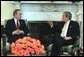 President George W. Bush talks with New York City Mayor Michael Bloomberg in the Oval Office Wednesday, March 19, 2003. Secretary of Homeland Security Tom Ridge, not pictured, also attended the meeting. The President discussed New York's security issues. White House photo by Eric Draper.