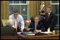 President George W. Bush receives an update on the status of military action in Iraq Thursday morning, March 20, 2003, in the Oval Office. Present are Vice President Dick Cheney, CIA Director George Tenet and Chief of Staff Andy Card. White House photo by Eric Draper