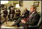 President George W. Bush talks with the press during a meeting with congressional leaders in the Oval Office Friday, March 21, 2003. Pictured with the President are, from left, House Minority Leader Nancy Pelosi, D-Calif., Speaker of the House Dennis Hastert, R-Ill., and Vice President Dick Cheney. White House photo by Paul Morse