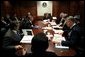 On Friday morning, March 21, 2003, President George W. Bush meets with his war council in the Situation Room of the White House. Present at the table are, from foreground, National Security Advisor Condoleezza Rice, CIA Director George Tenet, Chief of Staff Andy Card, Secretary of State Colin Powell, Secretary of Defense Donald Rumsfeld and Chairman of the Joint Chiefs of Staff Richard B. Myers. White House photo by Eric Draper