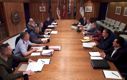 President George W. Bush meets with his war council at Camp David, Saturday morning, March 22, 2003. Present at the table are, from left, Vice Chairman of the Joint Chiefs of Staff Peter Pace, Chairman of the Joint Chiefs of Staff Richard B. Myers, Secretary of State Colin Powell, Secretary of Defense Donald Rumsfeld, Vice President Dick Cheney, Deputy Secretary of Defense Paul Wolfowitz, Chief of Staff to the Vice President Lewis Libby, Chief of Staff Andy Card, National Security Advisor Condoleezza Rice, CIA Director George Tenet, and Chief Counsel to the President Alberto Gonzalez. White House photo by Eric Draper