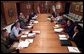 President George W. Bush meets with his war council at Camp David, Saturday morning, March 22, 2003. Present at the table are, from left, Vice Chairman of the Joint Chiefs of Staff Peter Pace, Chairman of the Joint Chiefs of Staff Richard B. Myers, Secretary of State Colin Powell, Secretary of Defense Donald Rumsfeld, Vice President Dick Cheney, Deputy Secretary of Defense Paul Wolfowitz, Chief of Staff to the Vice President Lewis Libby, Chief of Staff Andy Card, National Security Advisor Condoleezza Rice, CIA Director George Tenet, and Chief Counsel to the President Alberto Gonzalez.  White House photo by Eric Draper