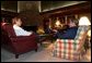 President George W. Bush and British Prime Minister Tony Blair meet, Wednesday night, March 26, 2003 at Camp David. Also pictured in background are Chief of Staff Andy Card and National Security Advisor Condoleezza Rice. White House photo by Eric Draper