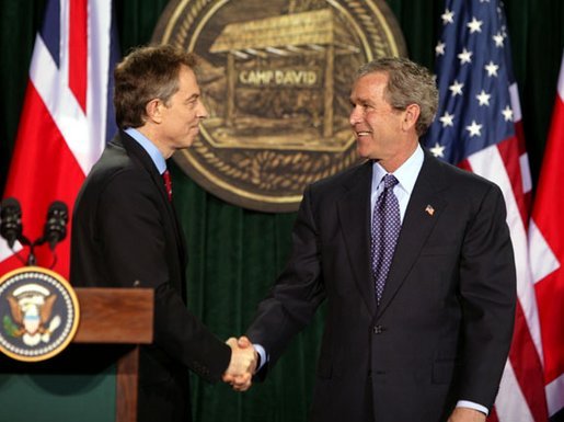 President George W. Bush and British Prime Minister Tony Blair shake hands after they conclude a joint news conference at the Camp David, March 27, 2003. "The United States and United Kingdom are acting together in a noble purpose. We're working together to make the world more peaceful; we're working together to make our respective nations and all the free nations of the world more secure; and we're working to free the Iraqi people," President Bush said. White House photo by Paul Morse