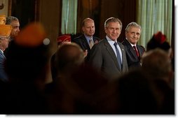 Standing with Secretary for Veterans Affairs Anthony Principi, right, President George W. Bush addresses national veterans service organizations in the East Room Friday, March 28, 2003. "Today's Armed Forces are upholding the finest traditions of our country and of our military. They are making great progress in the war in Iraq," said the President. "They are showing great courage and they are making this country proud."  White House photo by Paul Morse