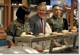 President George W. Bush and Mrs. Bush are served lunch with Marines at Camp Lejeune in Jacksonville, N.C., Thursday, April 3, 2003.   White House photo by Paul Morse