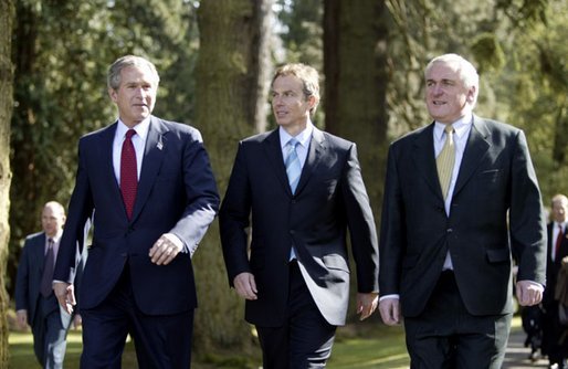 President George W. Bush walks with British Prime Minister Tony Blair, center, and Irish Prime Minister Bertie Ahern at Hillsborough Castle as he prepares to depart Northern Ireland Tuesday, April 8, 2003. White House photo by Paul Morse