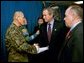 President George W. Bush and Laura Bush attend the U.S. Citizenship Ceremony for Marine Corps Mastery Gunnery Sgt. Guadalupe Denogean of Tucson, Ariz., at the National Naval Medical Center in Bethesda, Md., Friday, April 11, 2003. Pictured at far right, Eduardo Aguirre, Jr., Acting Director of the Bureau of Citizenship and Immigration Services, conducted the ceremony. White House photo by Eric Draper