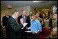 President George W. Bush attends the U.S. Citizenship Ceremony for Marine Corps Lance Cpl. O.J. Santamaria of Daly City, Calif., at the National Naval Medical Center in Bethesda, Md., Friday, April 11, 2003. White House photo by Eric Draper