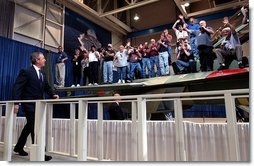 President George W. Bush walks to the stage as workers cheer during his introduction at the Boeing F-18 Production Facility in St. Louis, Mo., Wednesday, April 16, 2003.  White House photo by Eric Draper