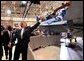 President George W. Bush reaches for a cap to sign after speaking at the Boeing F-18 Production Facility in St. Louis, Mo., Wednesday, April 16, 2003. White House photo by Eric Draper