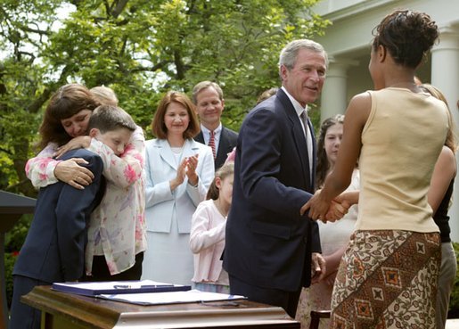 President George W. Bush greets Tamara Brooks after signing the S. 151, PROTECT Act of 2003, in the Rose Garden Wednesday, April 30, 2003. Brooks, 17, was rescued after an AMBER Alert was issued throughout Orange County, Calif., alerting the community of her abduction. Donna Norris, left, embraces her son Ricky after the bill signing. The AMBER Alert system is named in honor of her 9-year-old daughter, Amber Hagerman, who was abducted while playing near her Arlington, Texas, home and later found murdered. White House photo by Paul Morse