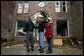 President George W. Bush comforts Scott and Annette Rector in front of their destroyed business in Pierce City, Mo., Tuesday, May 13, 2003. "You can't realize what it's like to see a tornado go right down the main street of a town and just wipe it out," said President Bush as he surveyed the damage from tornados that ripped through southwestern Missouri May 4. "It's hard to envision. But a lot of people know you're suffering, and a lot of people are praying for you, and a lot of people care for you. And a lot of people wish you all the best." White House photo by Susan Sterner