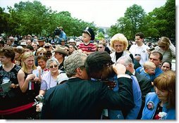 President George W. Bush comforts a woman during the Annual Peace Officers Memorial Service at the U.S. Capitol in Washington, D.C., Thursday, May 15, 2003. "I want to thank all the law enforcement officers who have come here today to honor the fallen," said the President in his remarks. "I particularly want to say to the families, there is a lot of love and compassion in this nation of ours. A lot of people pray for you,"  White House photo by Paul Morse