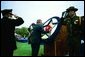 President George W. Bush places a flower on a memorial wreath during the Annual Peace Officers Memorial Service at the U.S. Capitol Washington, D.C., Thursday, May 15, 2003. White House photo by Paul Morse.