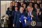 President George W. Bush receives a jersey during the presentation of the Commander-in-Chief's Trophy in the East Room Friday, May 16, 2003. "I'm proud to welcome back to the White House the Air Force Academy Falcons, who have now won the Commander-in-Chief's Trophy for their six consecutive year, and 16th time overall," said the President in his remarks. White House photo by Paul Morse