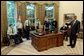 President George W. Bush talks with soldiers after taping his weekly radio address in the Oval Office Friday, May 16, 2003. Honoring Armed Forces Day on May 17th, the President invited soldiers to attend the recording of the address. White House photo by Eric Draper