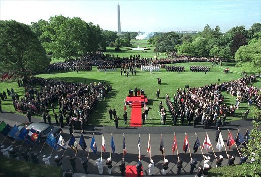 Flags are raised high as President George W. Bush hosts a State Arrival Ceremony for President Gloria Macapagal-Arroyo of the Philippines on the South Lawn Monday, May 19, 2003. "The Philippines was the first democracy in Asia and has a proud tradition of democratic values, love of family and faith in God. President Arroyo, you are carrying this tradition forward, and I'm proud to call you friend," said President Bush in his remarks. "Today the First Lady and I are honored to welcome you and Attorney Arroyo to America and to the White House. Mabuhay!" White House photo by Paul Morse