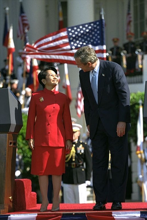 Sharing the stage with President Bush, Philippine President Arroyo is given a warm welcome by volleys of enthusiastic cheers during the South Lawn ceremony. White House photo by Eric Draper