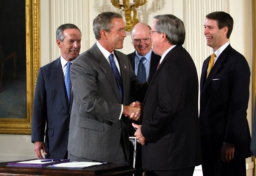 President George W. Bush shakes the hand of Congressman Bill Thomas, R-Calif., after signing the Jobs and Growth Tax Reconciliation Act of 2003 in the East Room Wednesday, May 28, 2003. Also pictured are, from left, Secretary of Commerce Donald Evans, Secretary of the Treasury John Snow and Senate Majority Leader Bill Frist, R-Tenn. White House photo by Eric Draper