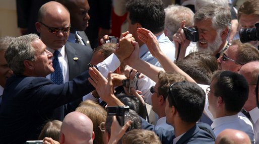 President George W. Bush greets the audience following his speech in the courtyard of the Wawel Royal Palace in Krakow, Poland, Saturday, May 31, 2003. White House photo by Paul Morse