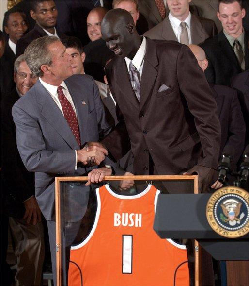 Congratulating the NCAA Winter Championship teams, President George W. Bush stands with Kueth Duany of Syracuse University's mens' basketball team in the East Room Tuesday, June 17, 2003. White House photo by Tina Hager