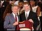 Congratulating the NCAA Winter Championship teams, President George W. Bush stands with Grant Potulny of the University of Minnesota-Twin Cities' men's hockey team in the East Room Tuesday, June 17, 2003. White House photo by Tina Hager