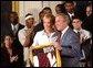 Congratulating the NCAA Winter Championship teams, President George W. Bush stands with Maria Roth of the University of Minnesota-Duluth's women's hockey team in the East Room Tuesday, June 17, 2003. White House photo by Tina Hager