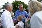 President George W. Bush greets guests at the Congressional Picnic on the South Lawn Wednesday, June 18, 2003. White House photo by Susan Sterner