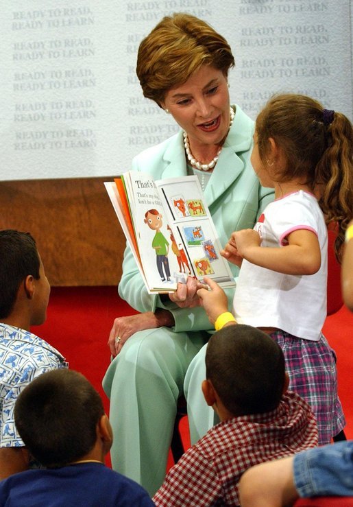 Laura Bush reads the book "That's My Dog" to students from the Clayton Center, a migrant Head Start Program, at the Raleigh Durham Airport in Raleigh, N.C. Friday, July 18, 2003. Mrs. Bush presented each child a book to help encourage reading and school readiness. White House photo by Tina Hager