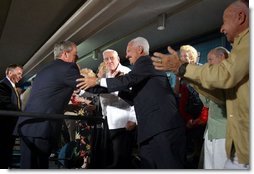 President George W. Bush and Health & Human Services Secretary Tommy Thompson, left, greet seniors at the Little Havana Activities and Nutrition Center in Miami, Fla., June 30, 2003.  White House photo by Paul Morse