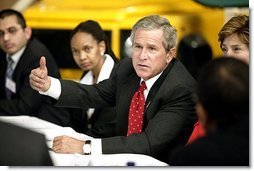 President George W. Bush talks with Ford Motor Company employees at the company's plant near Pretoria, South Africa, Wednesday July 9, 2003.  White House photo by Paul Morse