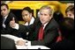 President George W. Bush talks with Ford Motor Company employees at the company's plant near Pretoria, South Africa, Wednesday July 9, 2003. White House photo by Paul Morse