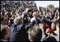 President George W. Bush greets an eager crowd upon his arrival at Sir Seretse Khama International Airport in Gaborone, Botswana, Thursday, July 10, 2003.