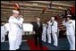 Sailors salute Vice President Dick Cheney as he departs the USS Ronald Reagan after the aircraft carrier's commissioning ceremony at the Norfolk Naval Station in Norfolk, Va., July 12, 2003.  White House photo by David Bohrer.