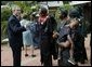 President George W. Bush talks with women who are members of Women and Children of Hope and the Nigerian Community of Western Living with AIDS at National Hospital in Abuja, Nigeria on July 12, 2003. White House photo by Paul Morse.