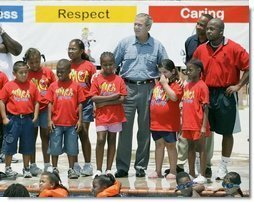 President George W. Bush views swimming pool activities of children during a tour of Lakewest Family YMCA in Dallas, Texas, Friday, July 18, 2003.  White House photo by Eric Draper