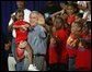 President George W. Bush joins children from Lakewest Family YMCA on stage after speaking on his Health and Fitness Initiative in Dallas, Texas, Friday, July 18, 2003. White House photo by Eric Draper