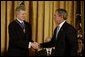 President George W. Bush presents the Presidential Medal of Freedom to Van Cliburn during a ceremony in the East Room Wednesday, July 23, 2003. Mr. Cliburn is a concert pianist whose talents have inspired countless artists. White House photo by Paul Morse