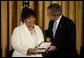 Vera Clemente accepts the Presidential Medal of Freedom from President George W. Bush on behalf of her husband Roberto Clemente Walker during a ceremony in the East Room Wednesday, July 23, 2003. A Hall of Fame baseball player, Mr. Clemente was committed to helping the less fortunate. The medal is the highest civilian award. White House photo by Paul Morse