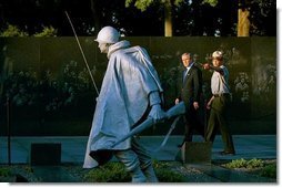 President George W. Bush and U.S. Park Ranger Lance Hatten tour the Korean War Veterans Memorial in Washington, D.C., Friday, July 25, 2003. Marking the 50th anniversary of the signing the armistice that ended the Korean war July 27, 1953, President Bush visited the memorial to honor those who served in the conflict.  White House photo by Paul Morse